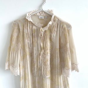 Pale yellow blouse with lace details